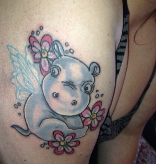 Cute Little Hippo Having Wings With Flowers Tattoo