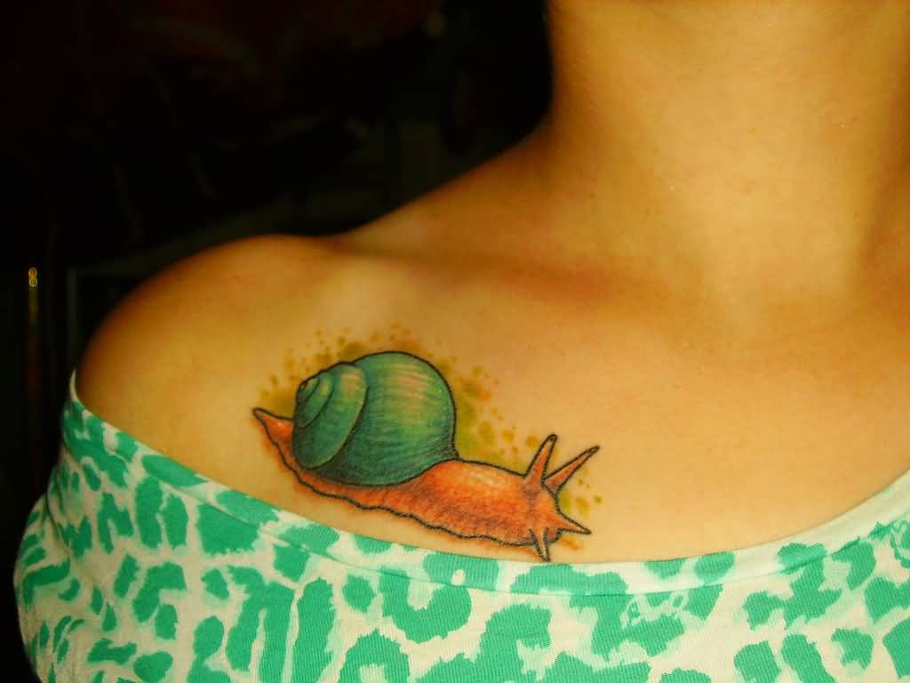 Cute Snail Colored Tattoo On Left Collar Bone