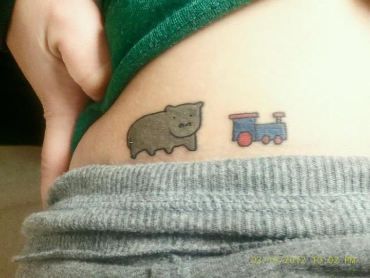 Cute Tiny Hippo With Tiny Train Tattoo On Waist