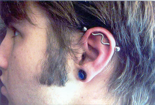 Gauge Left Ear Lobe And Industrial Piercing With Curved Barbell