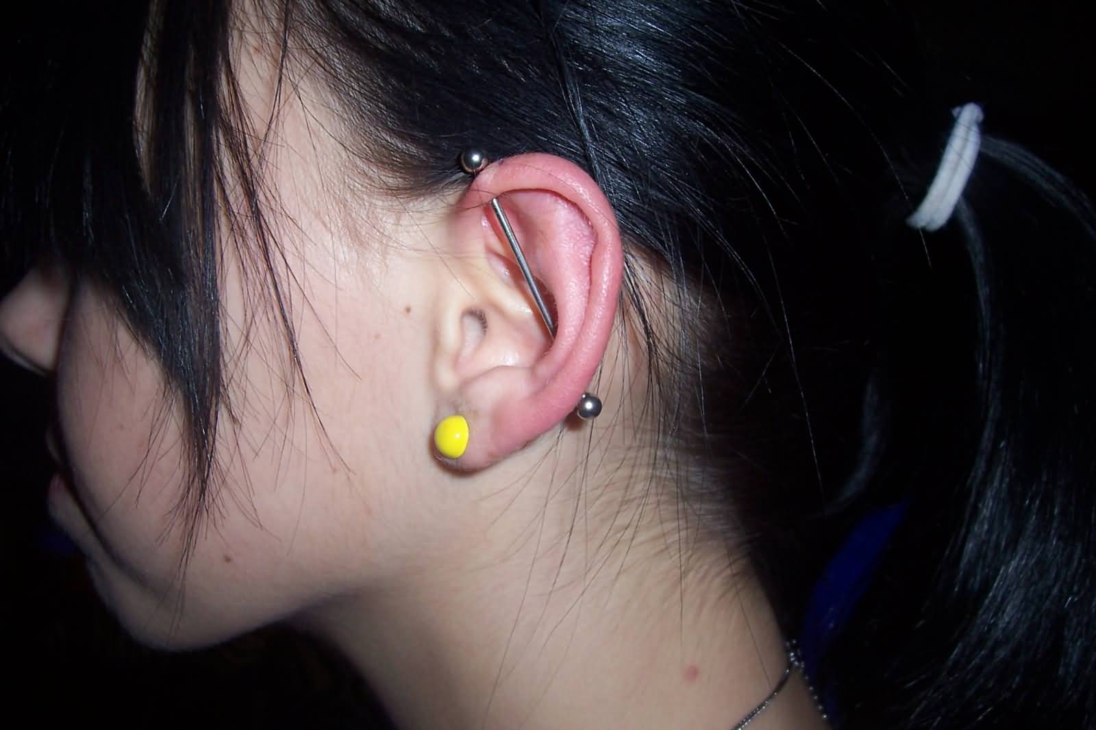 Girl With Ear Lobe And Industrial Piercing With silver Barbell