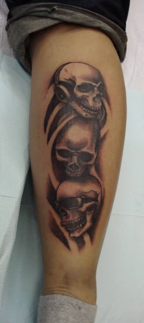 Grey And Black Evil Skulls Wearing Goggles And Headphones Tattoo