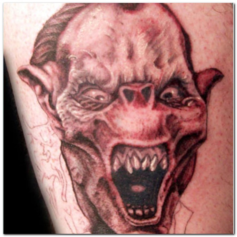 Grey Ink Angry Evil Head Tattoo