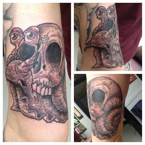 Grey Ink Skull And Snail Tattoo