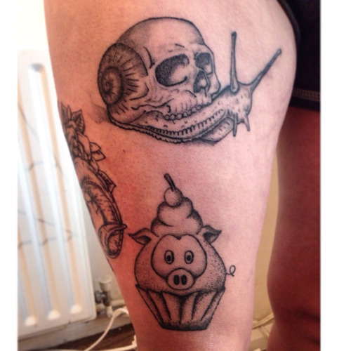 Grey Ink Snail Having Skull Shell With Pig Cupcake Tattoo