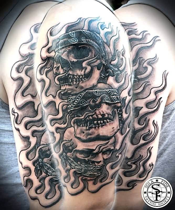 Grey Inked Tribal Evil Skulls Tattoo On Half Sleeve