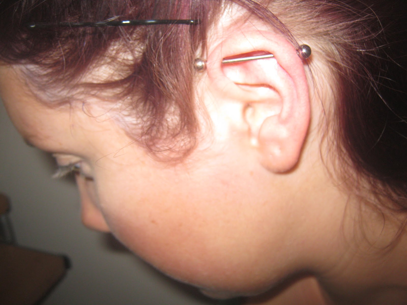 Industrial Piercing On Left Ear With Silver Barbell