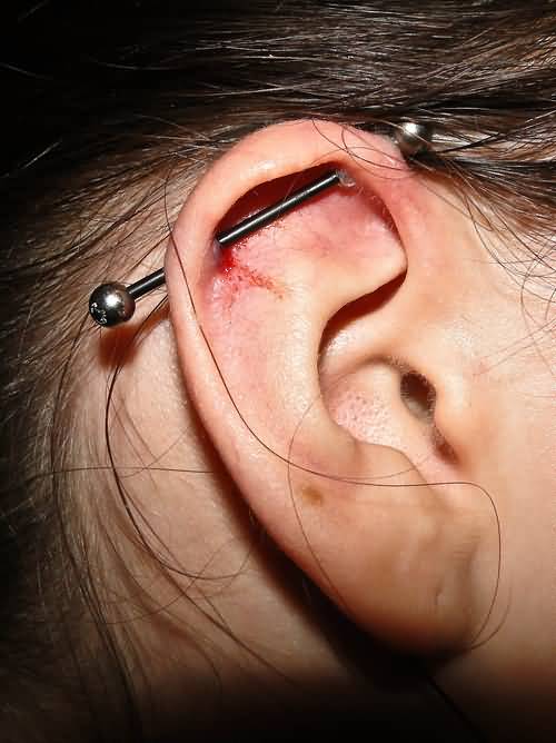 Industrial Piercing With Black Barbell On Right Ear