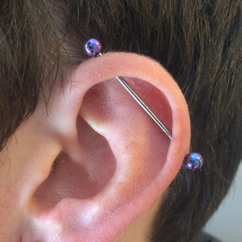 Industrial Piercing With Blue Barbell On Left Ear