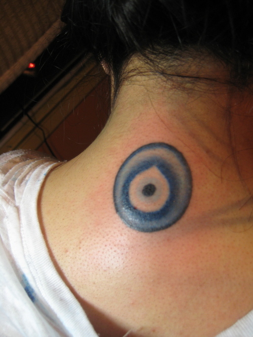 Nice Blue Evil Eye Tattoo On Nape