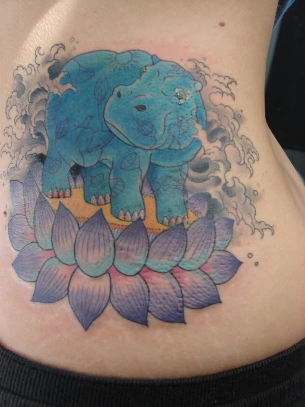 Nice Egyptian Hippo On Lotus Flower Tattoo On Side Rib