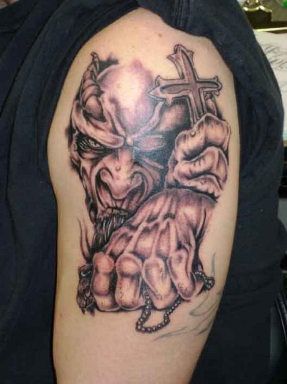 Nice Grey Ink Evil Holding Cross Tattoo On Left Shoulder