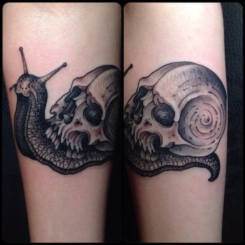 Nice Grey Skull And Snail Tattoo