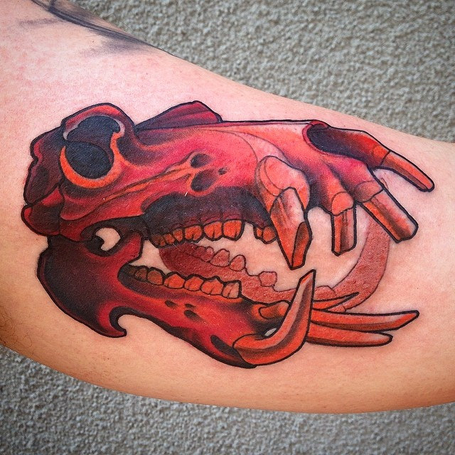 Nice Red Color Hippo Skull Tattoo On Bicep