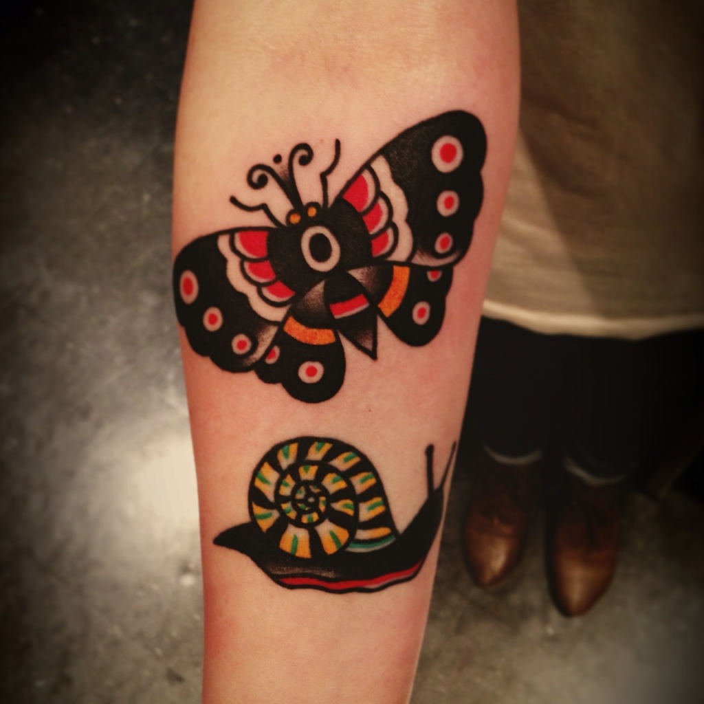 Nice Snail With Butterfly Traditional Tattoo On Forearm