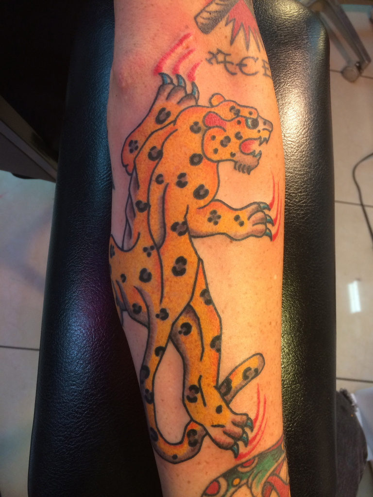 Nice Traditional Jaguar Scratching Tattoo On Forearm