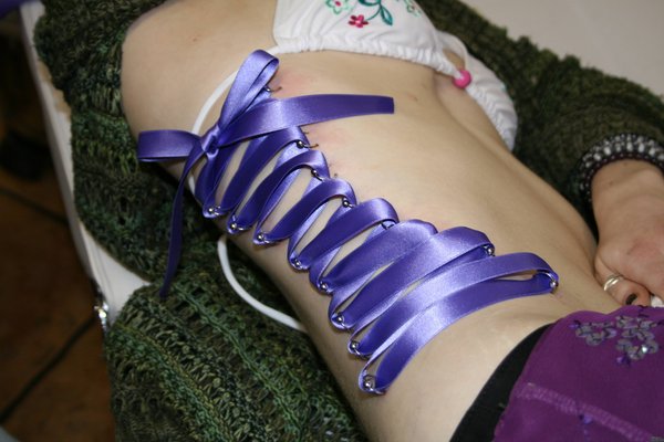 Purple Ink Corset Piercing On Side Rib by Kastrosama