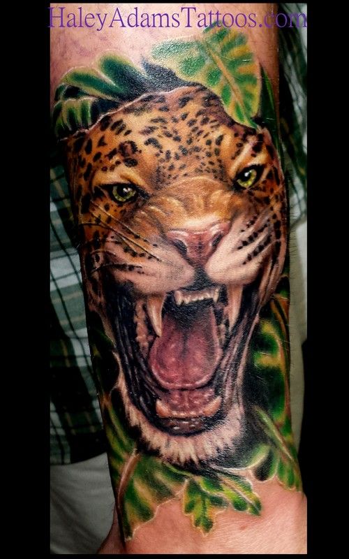 Realistic Angry Jaguar With Leaves Tattoo
