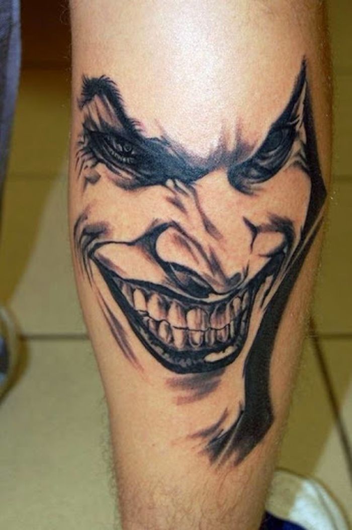 Realistic Colored Evil Joker Face Tattoo On Back Leg