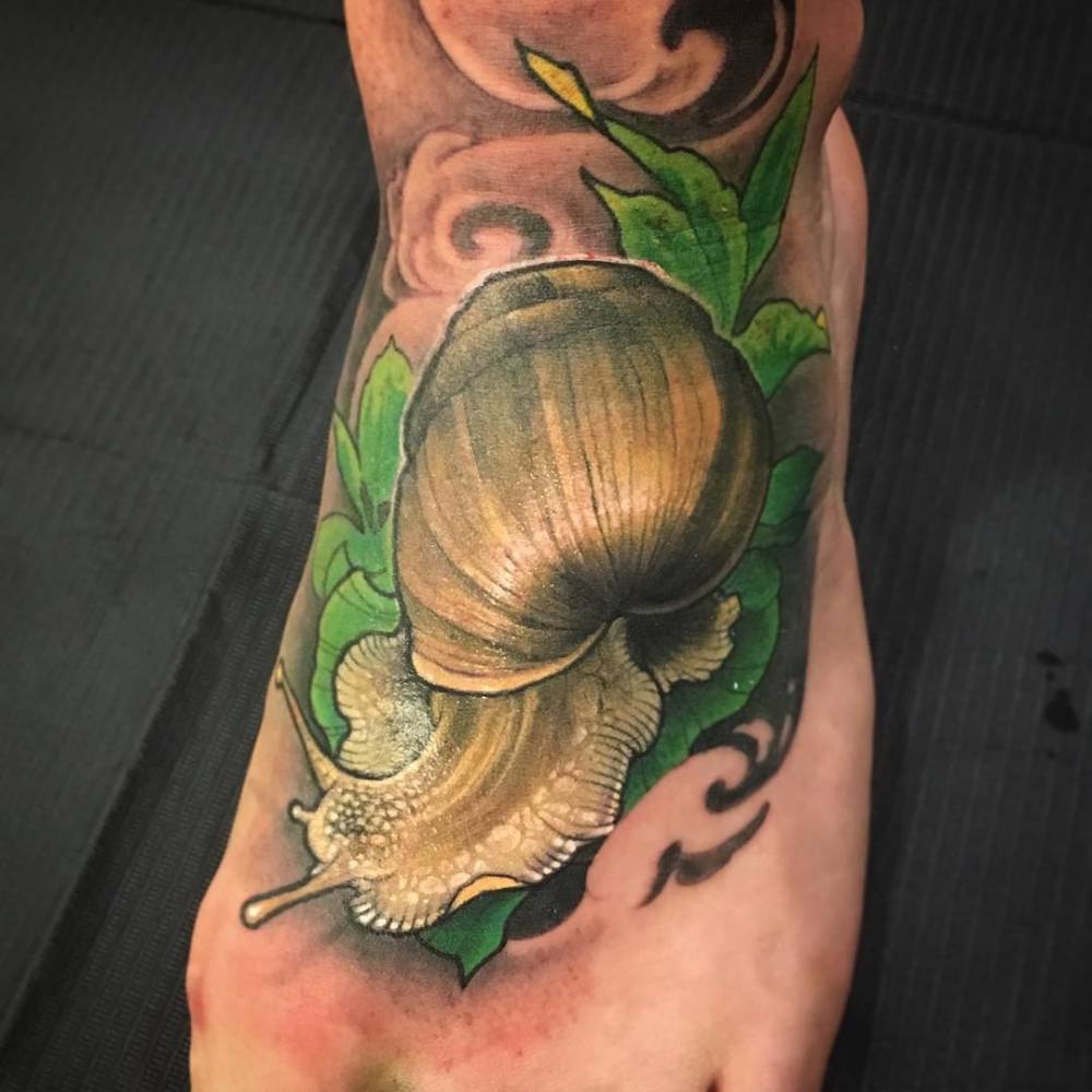 Realistic Snail With Green Leaves Tattoo On Foot By Logan