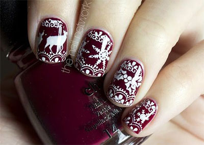 Red Base Nails With White Snowflakes And Reindeer Design Winter Nail Art