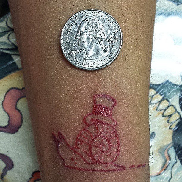 Red Ink Outline Snail With Hat Tattoo