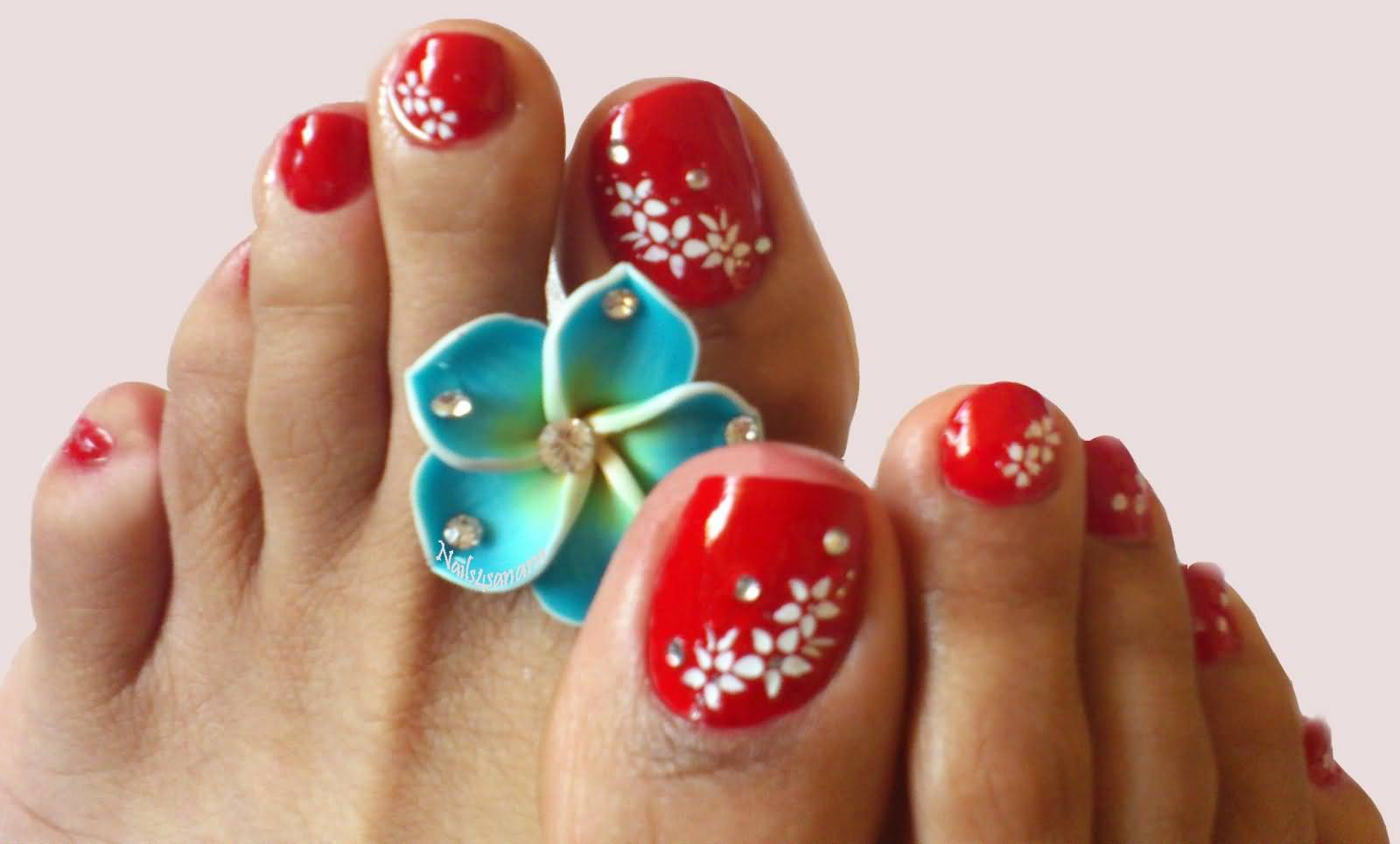 Red Toe Nails With White Flowers Design