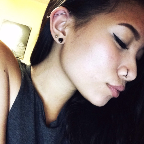 Right Nostril And Ear Lobe With Industrial Piercing