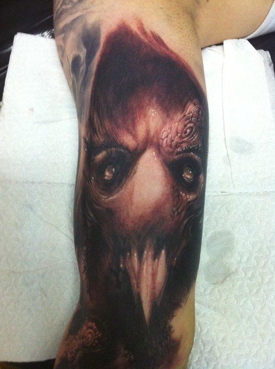 Scary Grey Ink Evil Face Tattoo On Bicep