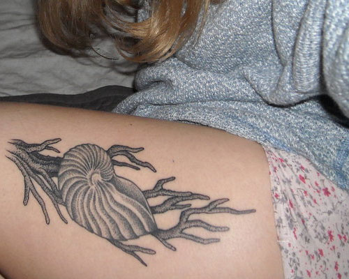 Simple Grey Ink Snail Shell Tattoo On Thigh