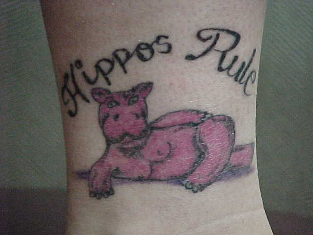 Simple Pink Cartoon Hippo With Lettering Tattoo