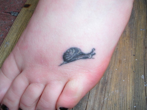 Smallest And Cute Grey Snail Tattoo On Foot