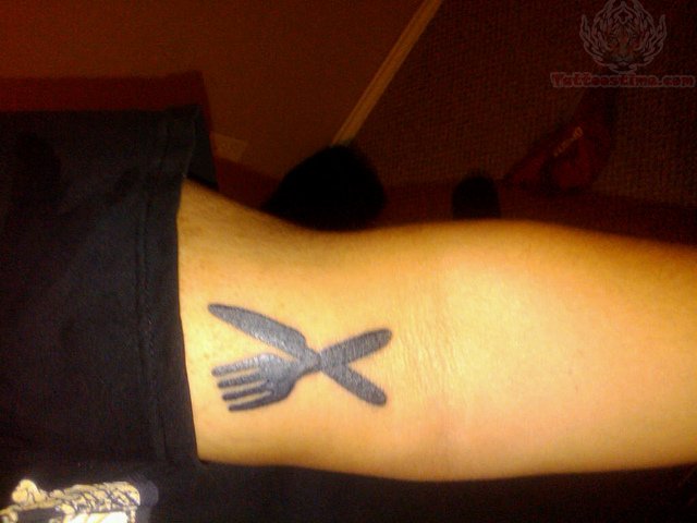 Tiny Crossed Knife And Fork Silhouette Tattoo On Bicep