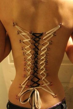 White And Black Corset Piercing On Back