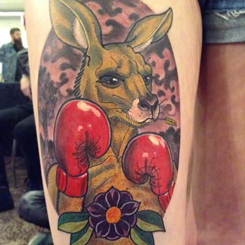 Wonderful Boxer Kangaroo In Circle Traditional Tattoo On Thigh
