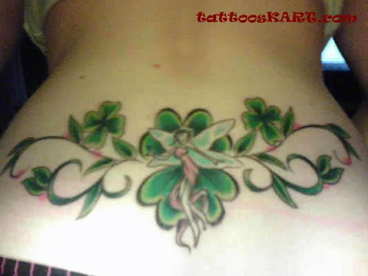 Amazing Fairy With Four Leaf Shamrocks Tattoo