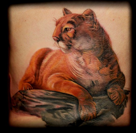 Amazing Realistic Puma Sitting Tattoo