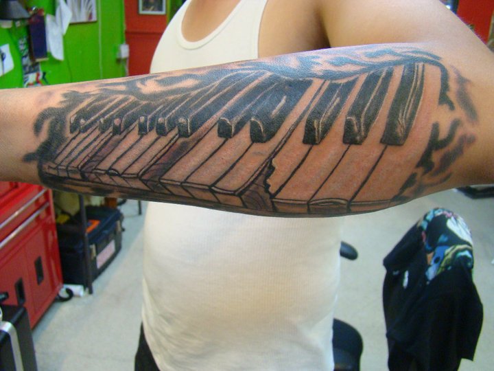 Awesome Black Ink Piano Keys Tattoo On Arm Sleeve