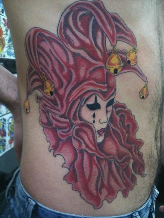 Awesome Color Ink Female Jester In Mask Tattoo On Side Rib