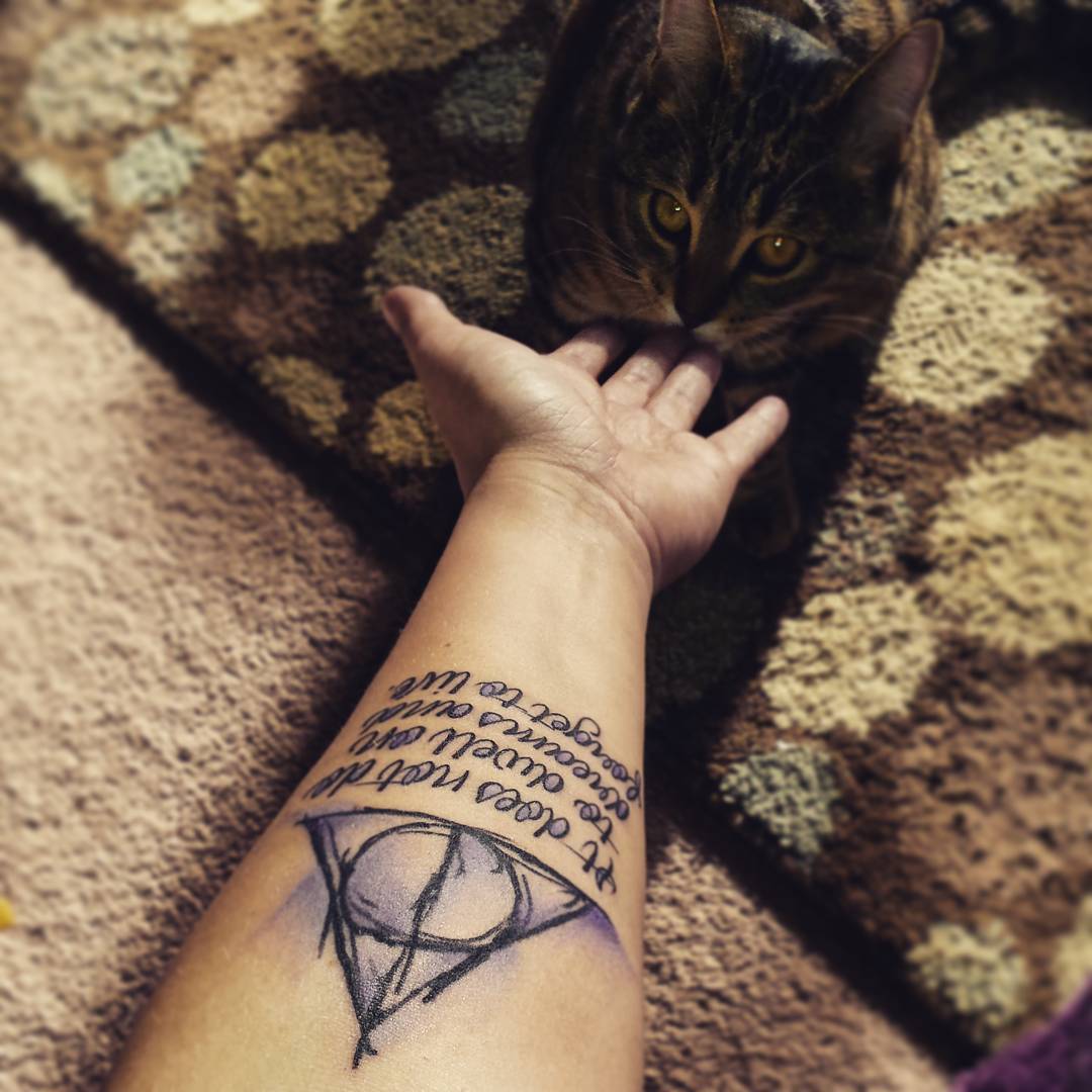 Awesome Deathly Hallows With Lettering Tattoo On Forearm