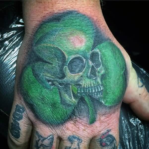 Awesome Green Skull On Shamrock Tattoo On Hand