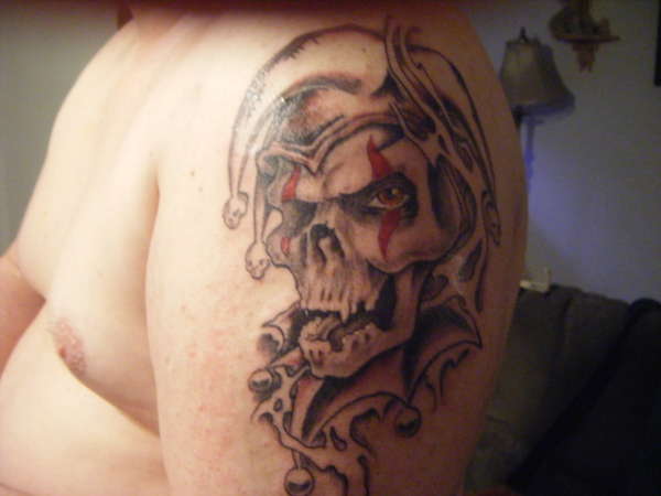 Awesome Grey Ink Evil Jester Skull Tattoo On Left Shoulder