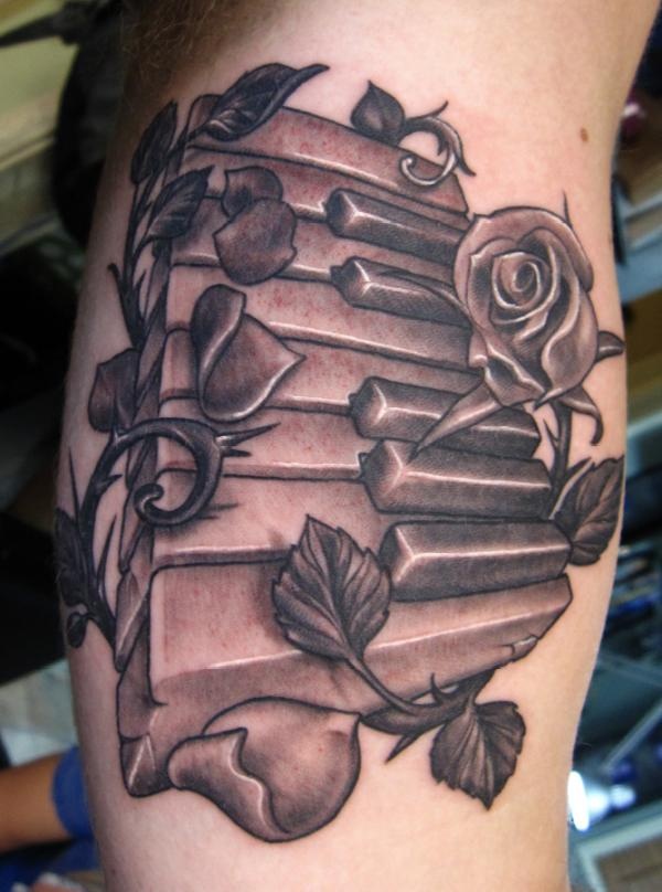 Awesome Grey Ink Rose And Piano Keys Tattoo