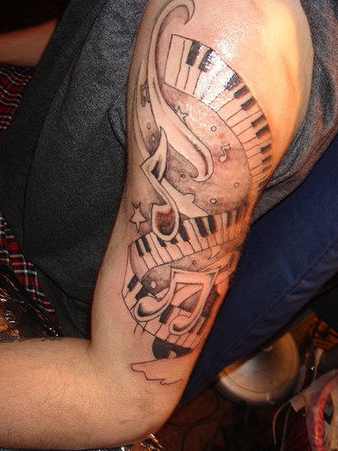 Awesome Grey Music Notes With Piano Keys Tattoo On Left Half Sleeve