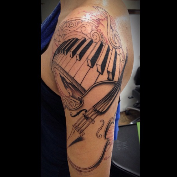 Awesome Piano Keys And Guitar Tattoo On Left Shoulder