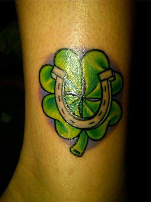 Awesome Small Four Leaf Shamrock With Horse Shoe Tattoo