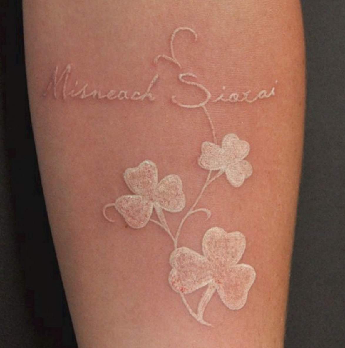 Awesome White Ink Shamrock Leaves With lettering Tattoo
