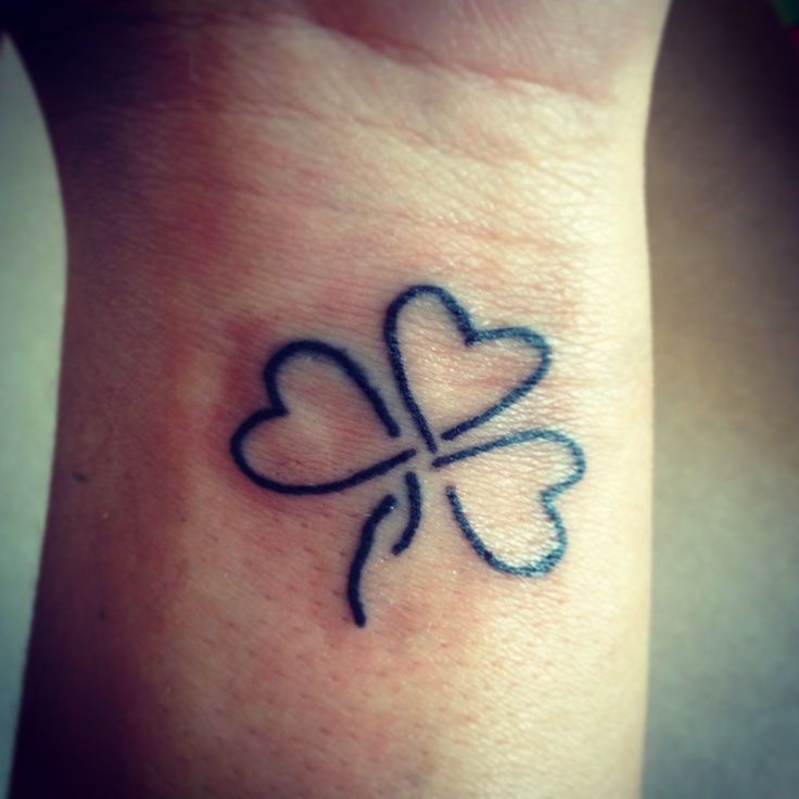 Black Ink Outline Shamrock Leaf Tattoo On Wrist