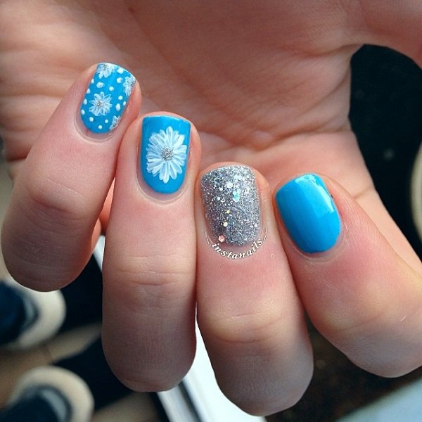 Blue Nails With White Flowers And Silver Glitter Accent Nail Art