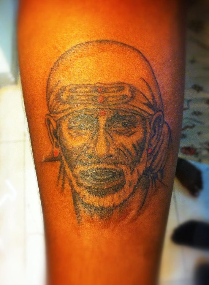 Brilliant Sai Baba Face Tattoo On Arm